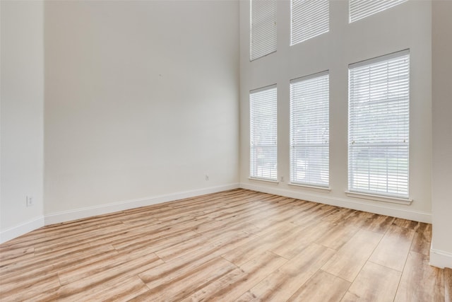 4513 Southpointe Dr, Richardson, TX 75082 - empty room featuring light wood-style flooring and a towering ceiling