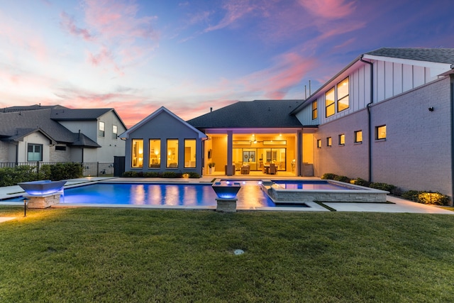 1454 Sunset Point Dr, Flower Mound, TX 75022 - pool at dusk with a pool with connected hot tub and a patio area
