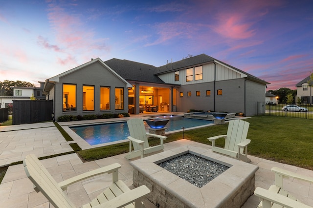 1454 Sunset Point Dr, Flower Mound, TX 75022 - back of house with an outdoor fire pit, a patio area, board and batten siding, and a pool with connected hot tub