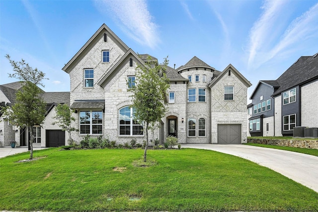 1018 Cascading Creek Dr, Rockwall, TX 75087 - french country home featuring stone siding, a front yard, concrete driveway, and an attached garage