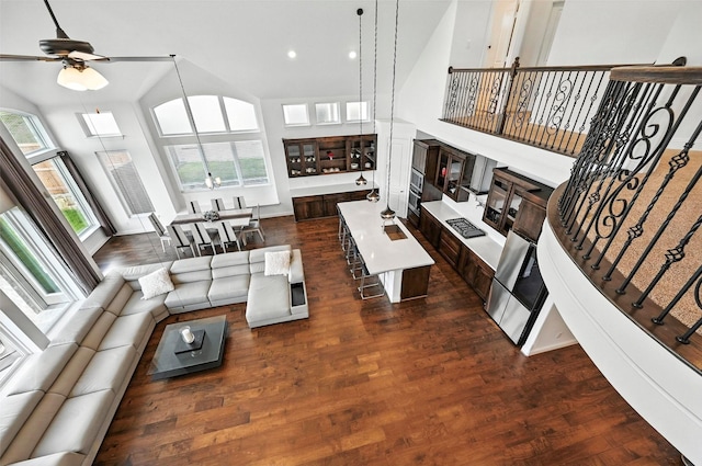 1018 Cascading Creek Dr, Rockwall, TX 75087 - living area featuring a ceiling fan, dark wood-style flooring, a high ceiling, and recessed lighting