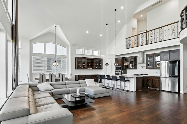 1018 Cascading Creek Dr, Rockwall, TX 75087 - living area featuring high vaulted ceiling, dark wood-type flooring, recessed lighting, and a chandelier