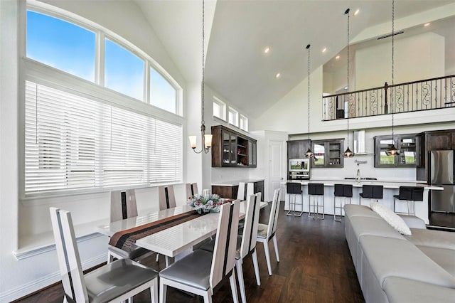 1018 Cascading Creek Dr, Rockwall, TX 75087 - dining area featuring high vaulted ceiling, dark wood finished floors, recessed lighting, and a chandelier