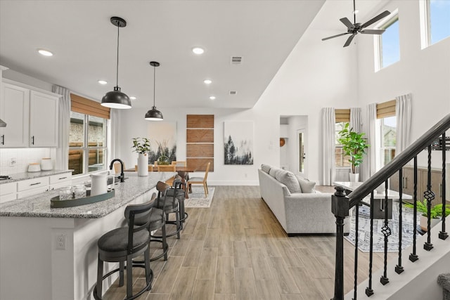 2100 Jade Forest Ln, Mesquite, TX 75181 - living room with a ceiling fan, healthy amount of natural light, recessed lighting, light wood-type flooring, and a high ceiling