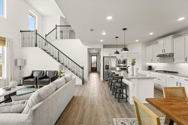 2100 Jade Forest Ln, Mesquite, TX 75181 - living room with stairway, recessed lighting, and light wood-type flooring