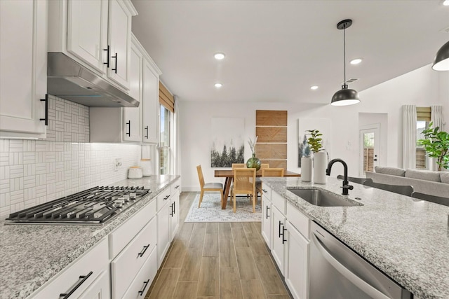 2100 Jade Forest Ln, Mesquite, TX 75181 - kitchen featuring stainless steel appliances, decorative backsplash, healthy amount of natural light, recessed lighting, and white cabinets