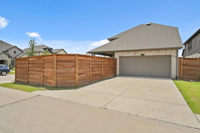 2100 Jade Forest Ln, Mesquite, TX 75181 - view of property exterior featuring a shingled roof, concrete driveway, and a garage
