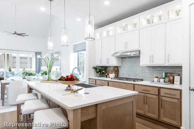 3613 Barrel Ln, Aubrey, TX 76227 - kitchen featuring stainless steel gas stovetop, under cabinet range hood, light countertops, backsplash, and recessed lighting