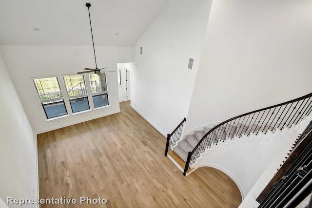3613 Barrel Ln, Aubrey, TX 76227 - stairway with high vaulted ceiling, wood finished floors, and ceiling fan