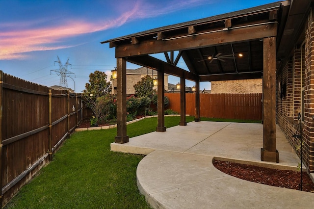 3901 Tule Ranch Rd, Fort Worth, TX 76262 - yard at dusk featuring a ceiling fan, a fenced backyard, and a patio