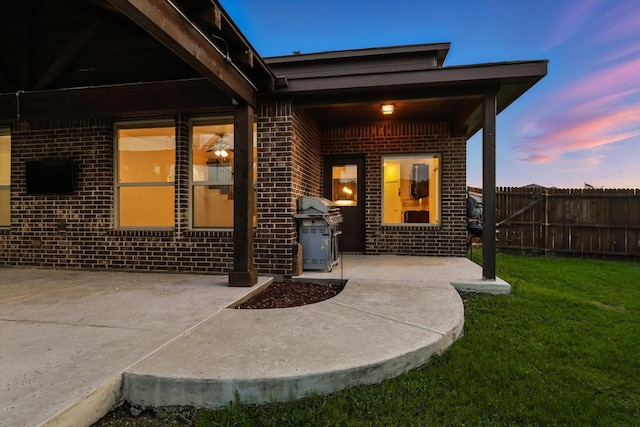 3901 Tule Ranch Rd, Fort Worth, TX 76262 - exterior entry at dusk featuring brick siding and a patio area