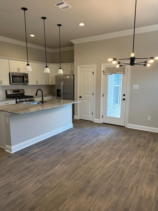 724 Esau Ave, Bossier City, LA 71111 - kitchen featuring appliances with stainless steel finishes, ornamental molding, a chandelier, white cabinetry, and dark wood-style flooring