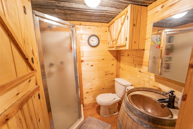 9504 County Road 197, Breckenridge, TX 76424 - bathroom featuring a shower stall, wooden walls, wood finished floors, and vanity