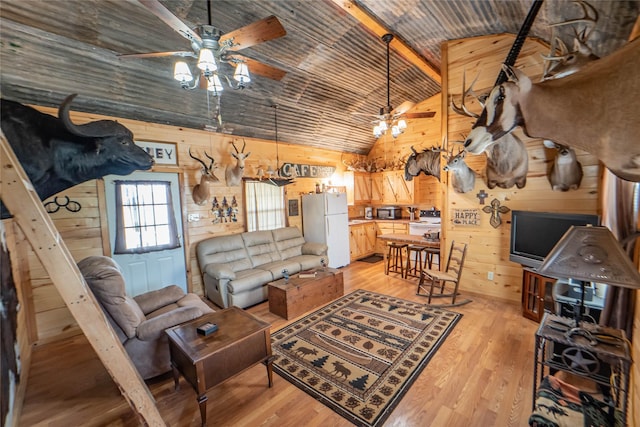 9504 County Road 197, Breckenridge, TX 76424 - living room with wooden walls, a ceiling fan, light wood finished floors, and high vaulted ceiling