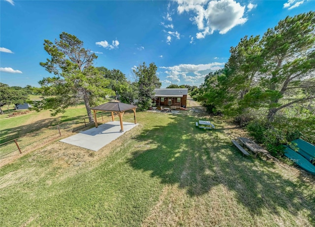 9504 County Road 197, Breckenridge, TX 76424 - view of green lawn featuring a gazebo and a patio area