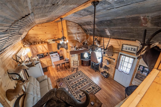 9504 County Road 197, Breckenridge, TX 76424 - living room featuring lofted ceiling, wooden walls, and wood finished floors
