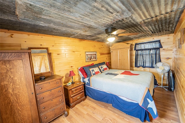 9504 County Road 197, Breckenridge, TX 76424 - bedroom featuring light wood-type flooring, wooden ceiling, wood walls, and a ceiling fan
