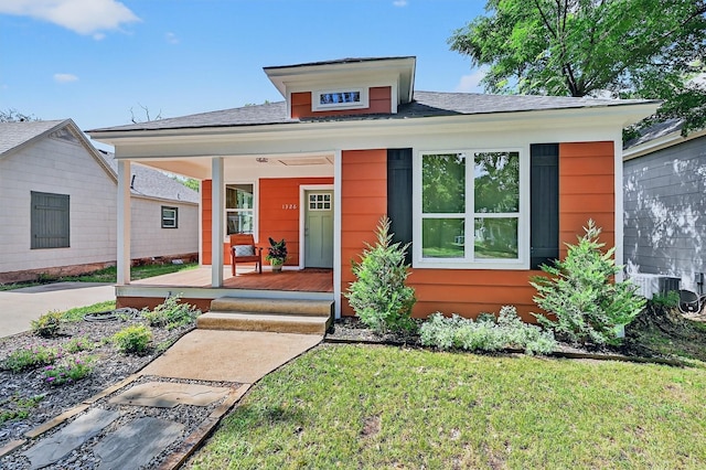 1326 W Bond St, Denison, TX 75020 - view of front of house featuring a porch, a front yard, and roof with shingles
