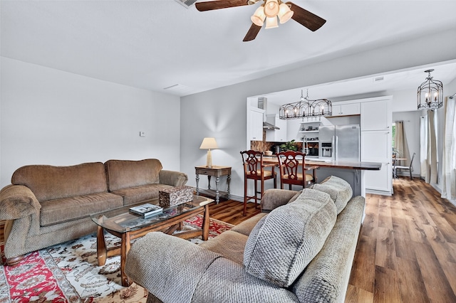 1326 W Bond St, Denison, TX 75020 - living room featuring a chandelier, a ceiling fan, and light wood finished floors