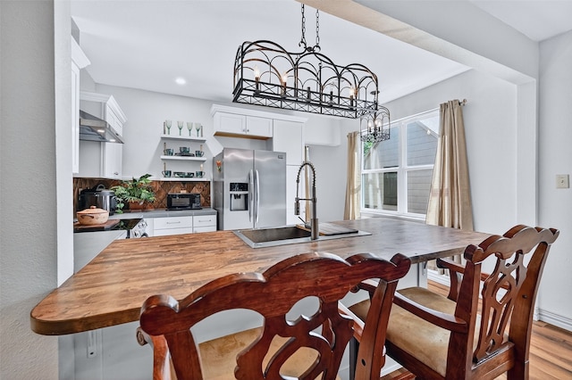 1326 W Bond St, Denison, TX 75020 - dining room featuring a chandelier, recessed lighting, and light wood-style floors