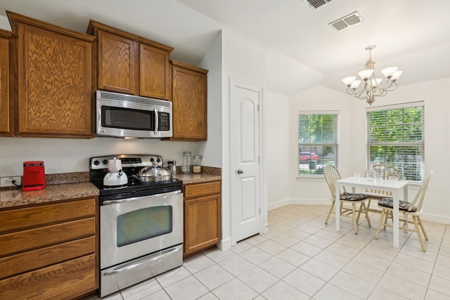 913 Lovebird Ln, Little Elm, TX 75068 - kitchen with appliances with stainless steel finishes, brown cabinets, a chandelier, vaulted ceiling, and light tile patterned floors