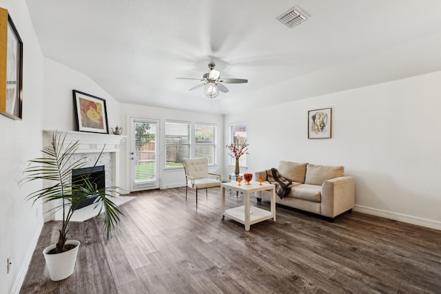 913 Lovebird Ln, Little Elm, TX 75068 - living area featuring a ceiling fan, a premium fireplace, and dark wood-style flooring