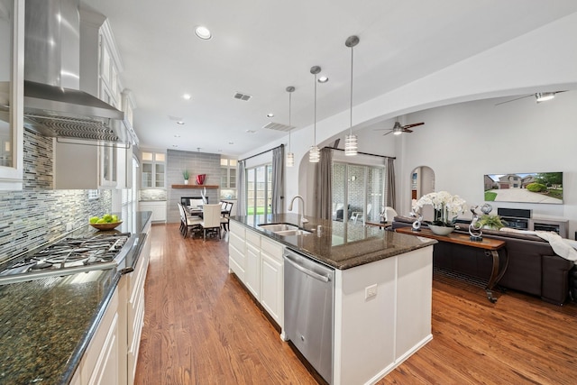 4652 Man O War Rd, Carrollton, TX 75010 - kitchen with stainless steel appliances, wall chimney exhaust hood, open floor plan, ceiling fan, and white cabinetry