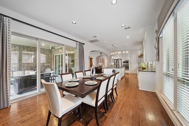 4652 Man O War Rd, Carrollton, TX 75010 - dining room with arched walkways, wood finished floors, and recessed lighting