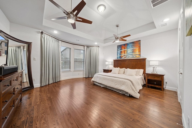 4652 Man O War Rd, Carrollton, TX 75010 - bedroom with dark wood finished floors, a tray ceiling, recessed lighting, ceiling fan, and access to exterior