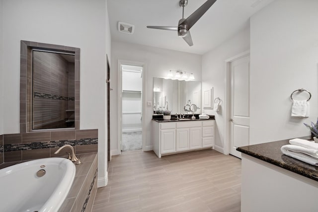 4652 Man O War Rd, Carrollton, TX 75010 - full bathroom with vanity, a bath, and ceiling fan