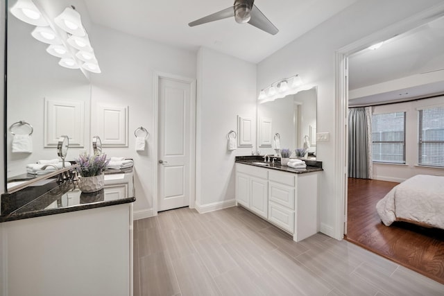 4652 Man O War Rd, Carrollton, TX 75010 - ensuite bathroom featuring two vanities, a ceiling fan, and wood finished floors