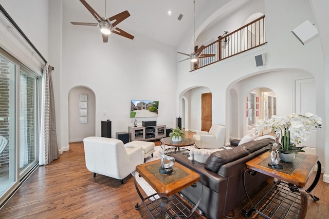 4652 Man O War Rd, Carrollton, TX 75010 - living room featuring a ceiling fan, arched walkways, high vaulted ceiling, and wood finished floors