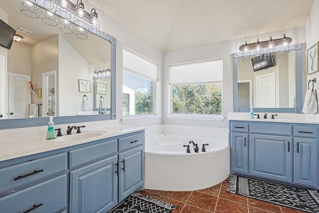 7910 Stone Ridge Dr, Northlake, TX 76247 - bathroom with two vanities, a garden tub, and vaulted ceiling
