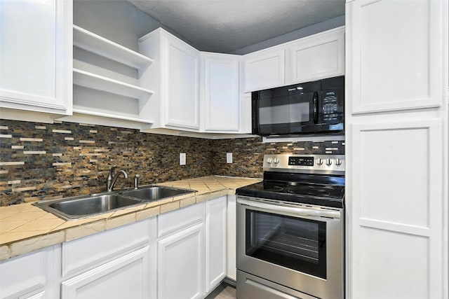 216 N Dobson St, Burleson, TX 76028 - kitchen with black microwave, stainless steel electric range, open shelves, white cabinets, and tasteful backsplash