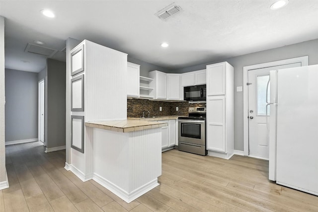216 N Dobson St, Burleson, TX 76028 - kitchen featuring freestanding refrigerator, stainless steel range with electric stovetop, black microwave, open shelves, and white cabinets