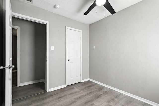 216 N Dobson St, Burleson, TX 76028 - unfurnished bedroom featuring wood finished floors and ceiling fan