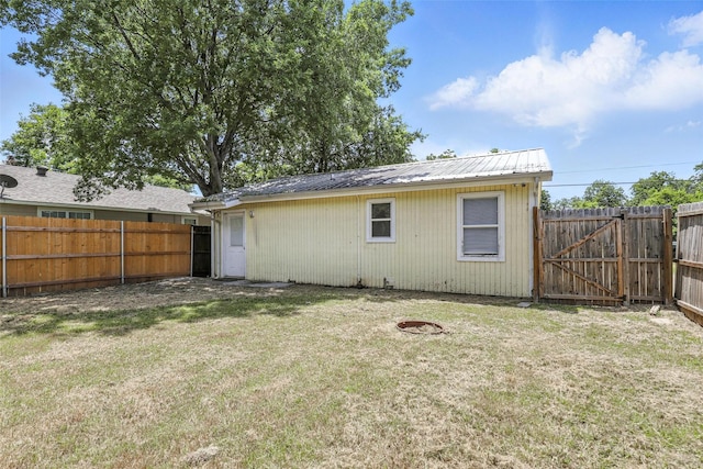 216 N Dobson St, Burleson, TX 76028 - rear view of house featuring a fenced backyard, a metal roof, and a gate