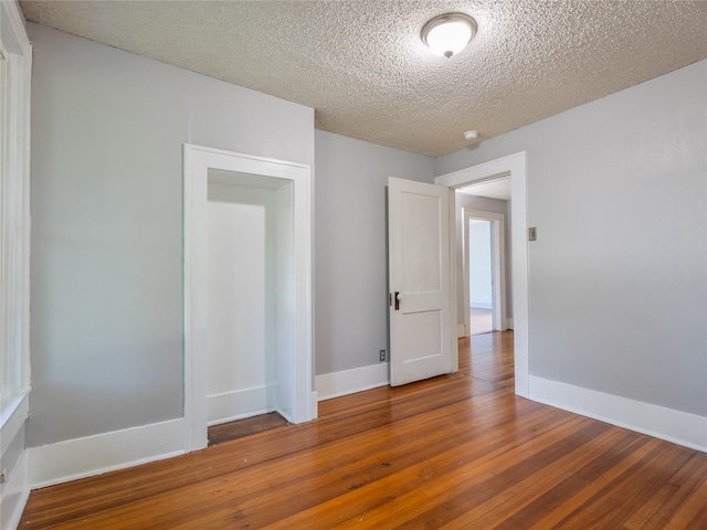 1114 W Congress St, Denton, TX 76201 - empty room featuring wood finished floors and a textured ceiling
