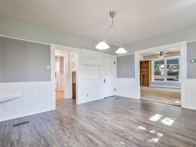 1114 W Congress St, Denton, TX 76201 - spare room with wainscoting, wood finished floors, a decorative wall, and a ceiling fan