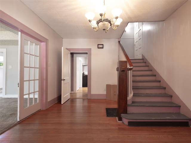 1114 W Congress St, Denton, TX 76201 - stairs featuring a chandelier and wood finished floors