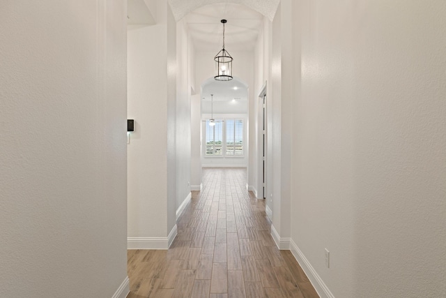 16317 Bidwell Park Dr, Prosper, TX 75078 - hall featuring wood finished floors, a textured wall, and arched walkways