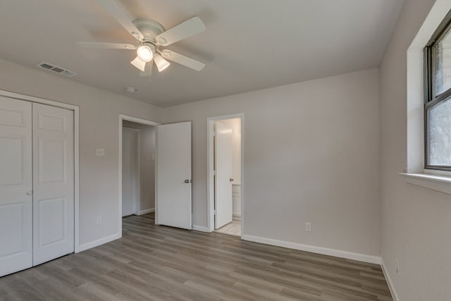 1006 Sleepy Hollow Dr, Garland, TX 75043 - unfurnished bedroom featuring wood finished floors, a closet, ensuite bathroom, and ceiling fan