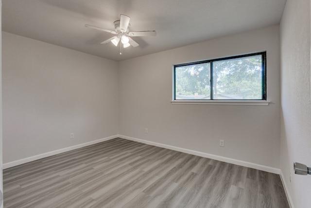 1006 Sleepy Hollow Dr, Garland, TX 75043 - empty room with wood finished floors and a ceiling fan