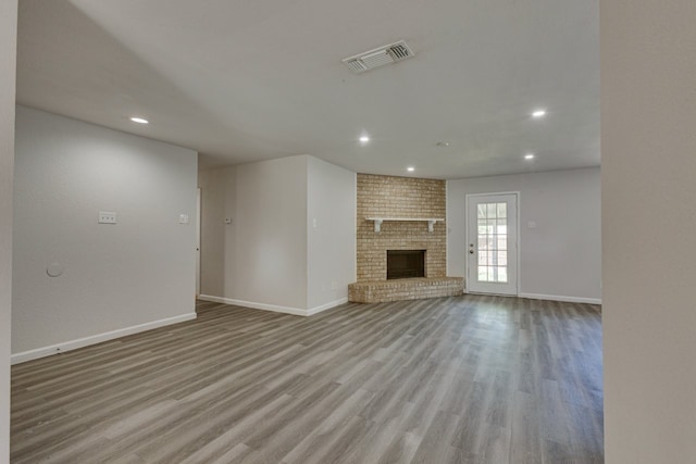 1006 Sleepy Hollow Dr, Garland, TX 75043 - unfurnished living room with recessed lighting, wood finished floors, and a fireplace