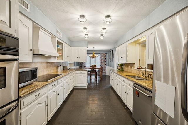 1509 Bar Harbor Dr, Dallas, TX 75232 - kitchen with appliances with stainless steel finishes, brick flooring, custom exhaust hood, decorative backsplash, and white cabinets