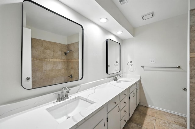 8109 Starnes Rd, North Richland Hills, TX 76182 - full bath with double vanity, tile patterned flooring, a tile shower, and recessed lighting