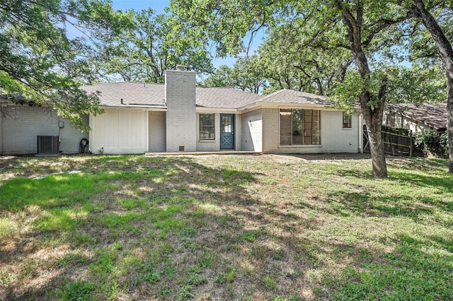 8109 Starnes Rd, North Richland Hills, TX 76182 - back of house featuring brick siding, a chimney, and roof with shingles