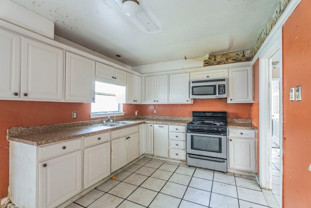 4608 Sandra Lynn Dr, Mesquite, TX 75150 - kitchen with stainless steel appliances, light tile patterned floors, and white cabinets
