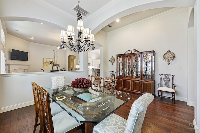 1682 Morris Ln, Frisco, TX 75034 - dining space featuring a chandelier, arched walkways, crown molding, wood finished floors, and recessed lighting