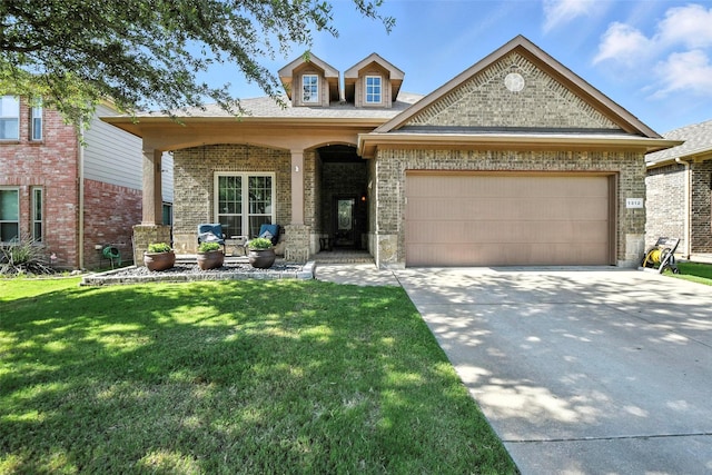 1312 Castlegar Ln, Fort Worth, TX 76247 - view of front of home featuring an attached garage, concrete driveway, a front yard, and brick siding